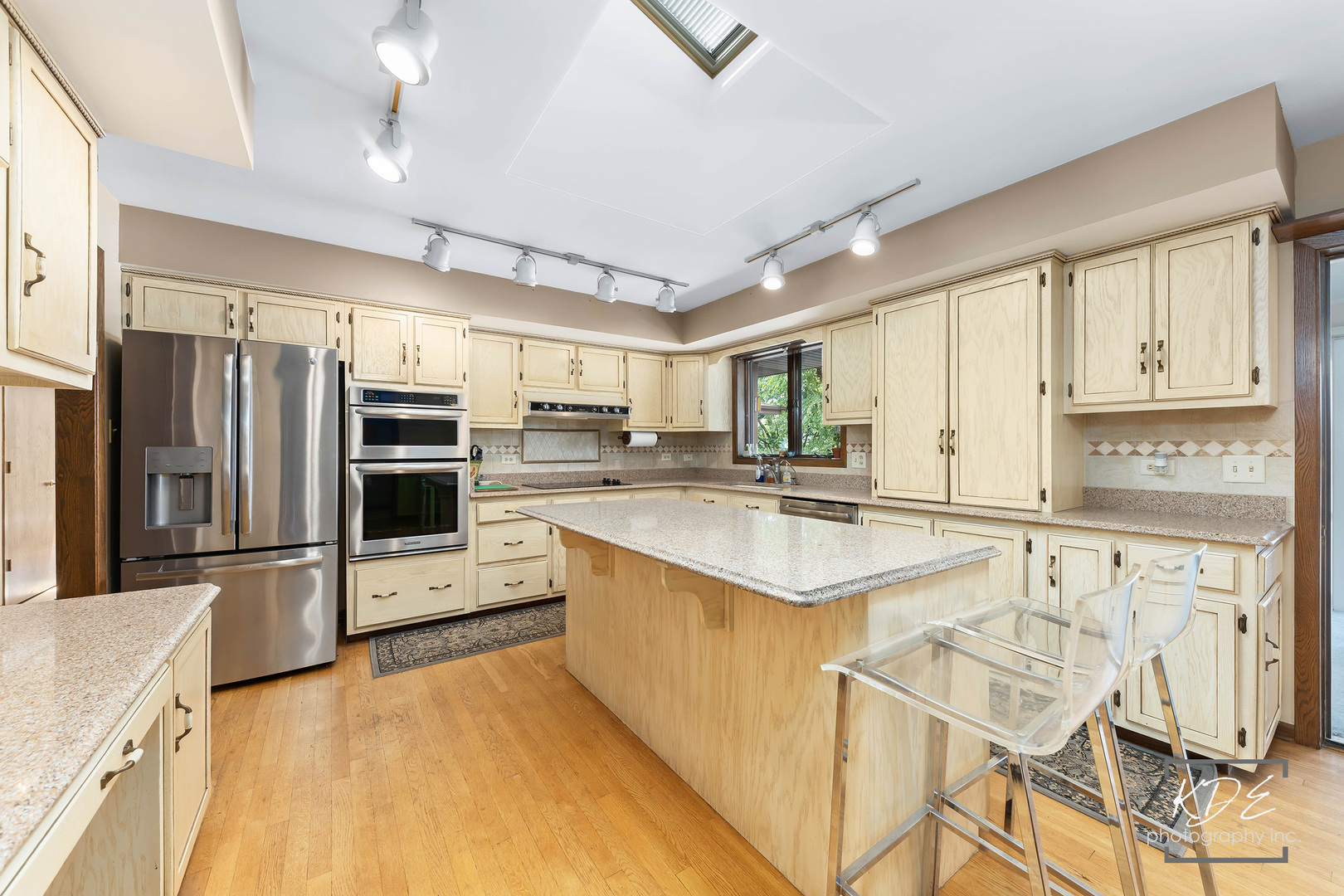 23211 Pilcher Road Plainfield, IL 60544 - Photo 21 of 58 a kitchen with stainless steel appliances kitchen island granite countertop a stove a sink and a refrigerator