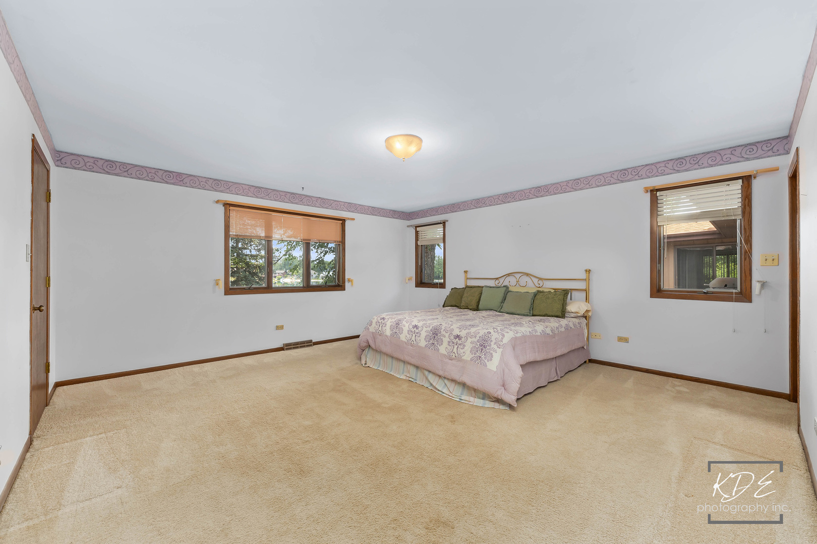 23211 Pilcher Road Plainfield, IL 60544 - Photo 30 of 58 a spacious bedroom with a bed and a couch