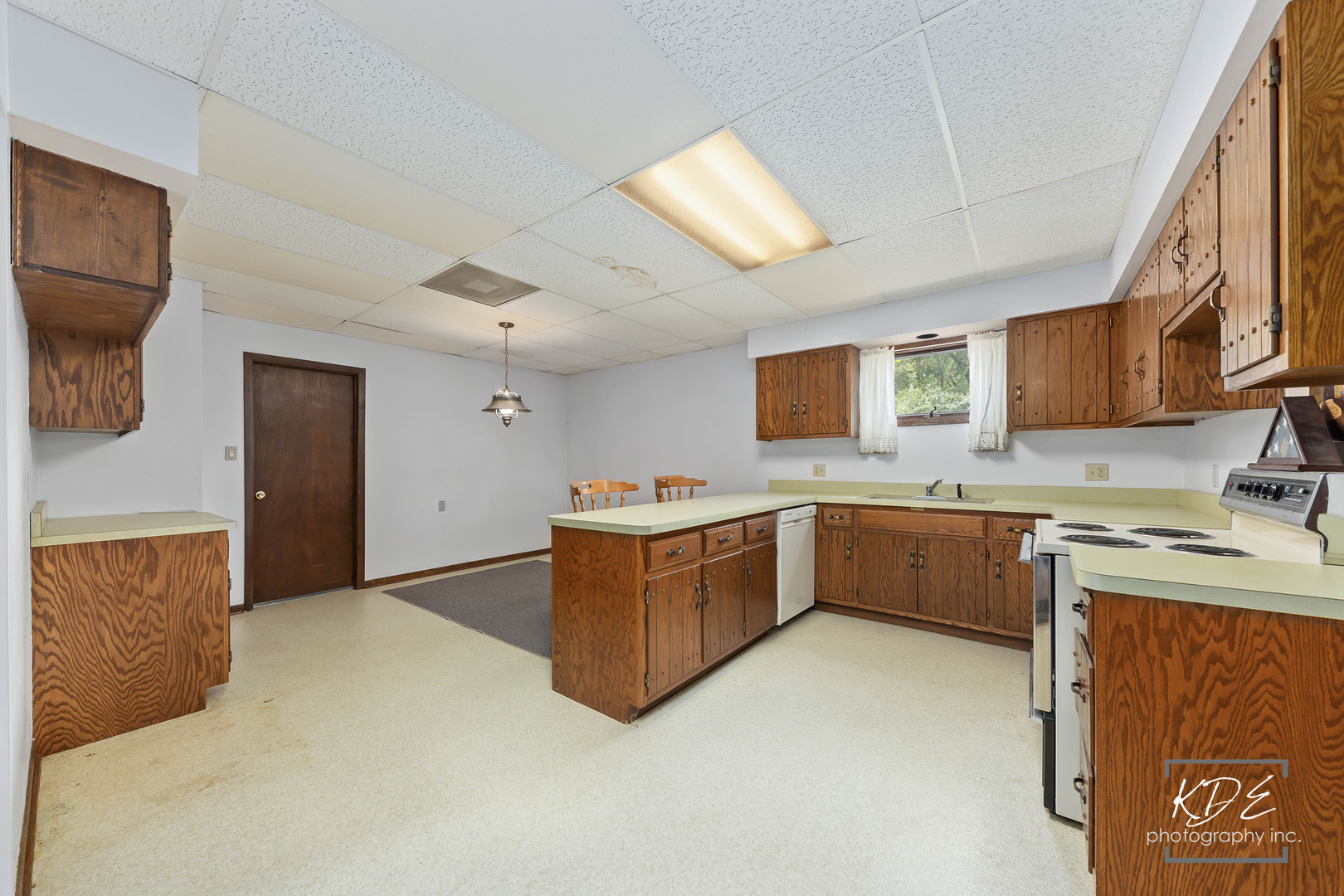 23211 Pilcher Road Plainfield, IL 60544 - Photo 42 of 58 a kitchen with a stove a sink and a refrigerator
