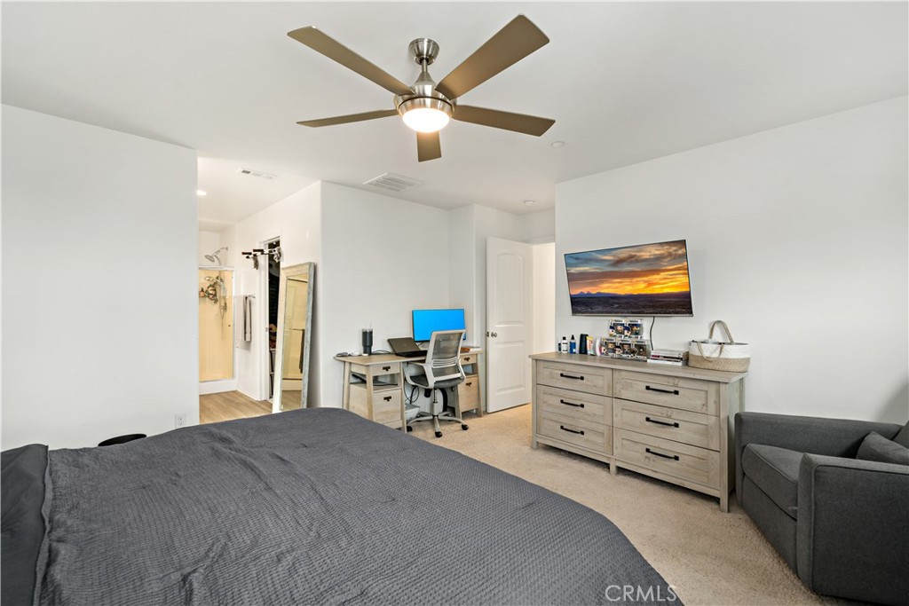 30271 Ramsay Drive Menifee, CA 92584 - Photo 16 of 34 a bed room with furniture and a flat screen tv