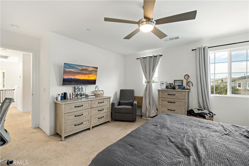 30271 Ramsay Drive Menifee, CA 92584 - Photo 17 of 34 a bedroom with furniture and a flat screen tv