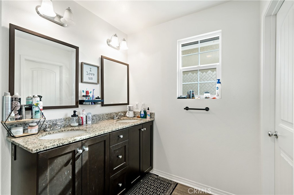 30271 Ramsay Drive Menifee, CA 92584 - Photo 18 of 34 a bathroom with a sink and a mirror