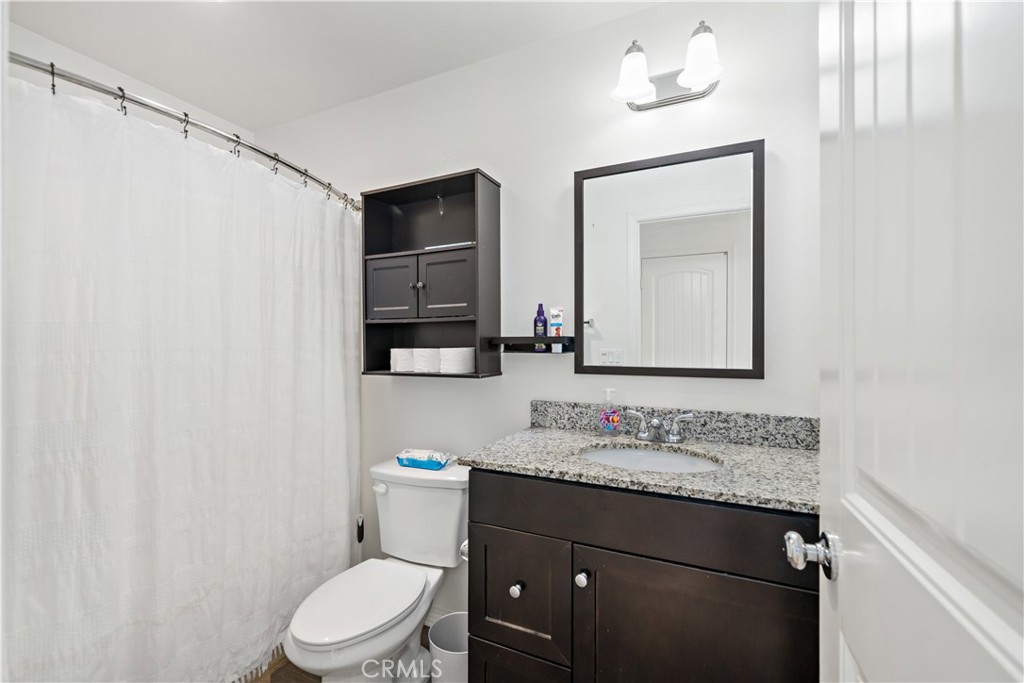 30271 Ramsay Drive Menifee, CA 92584 - Photo 21 of 34 a bathroom with a granite countertop sink vanity mirror and toilet