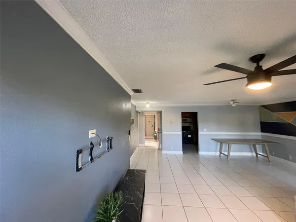 a view of a hallway with wooden floor and furniture