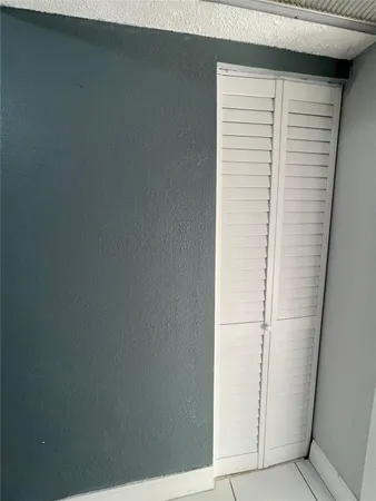 a view of a closet area with an empty room