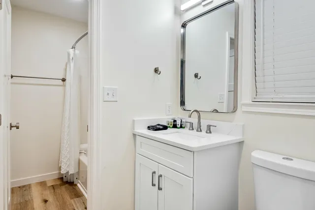 a bathroom with a sink toilet and shower
