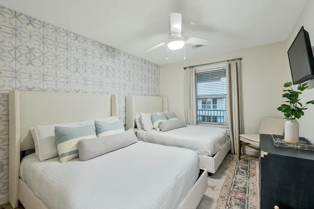 a bedroom with bed and a potted plant