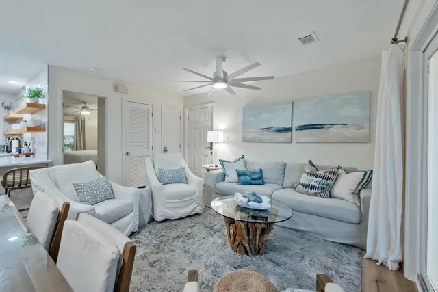 a living room with furniture a rug and a chandelier