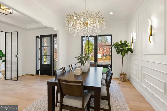 a hallway with white cabinets and wooden floor