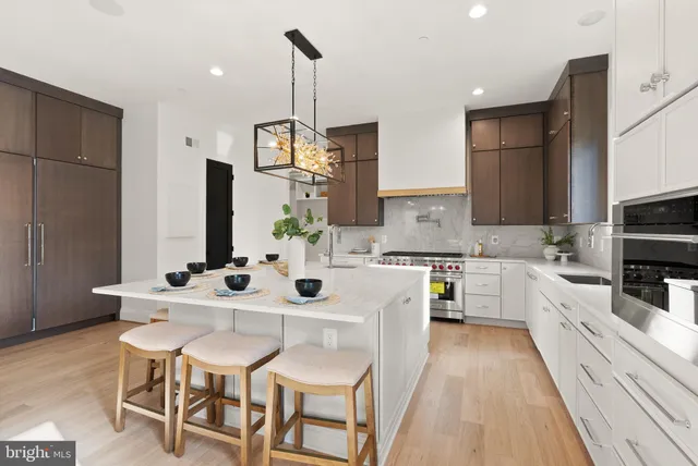 a kitchen with stainless steel appliances kitchen island granite countertop a sink and cabinets