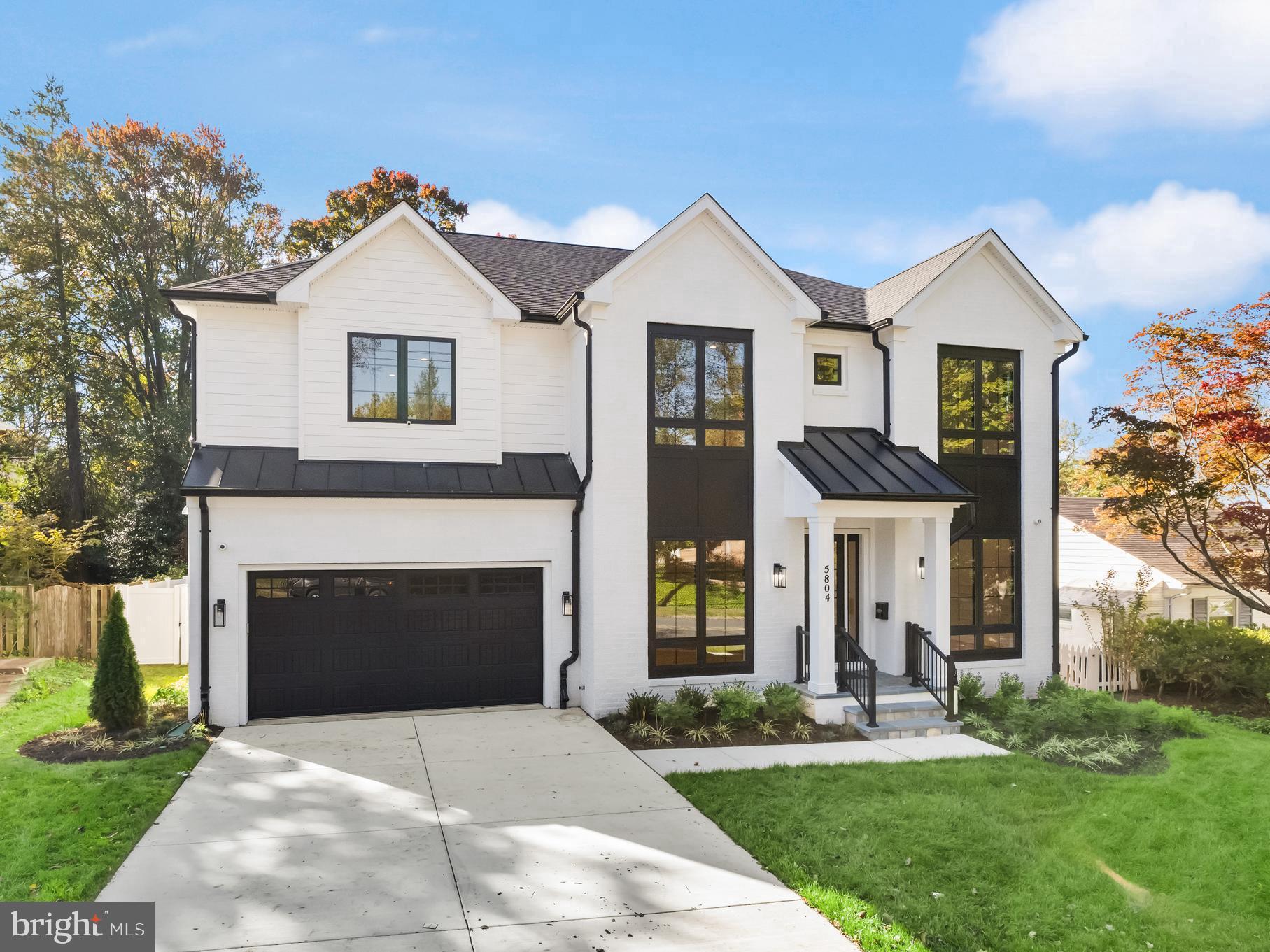 5804 Ridgefield Road Bethesda, MD 20816 - Photo 2 of 53 a front view of a house with a yard and garage
