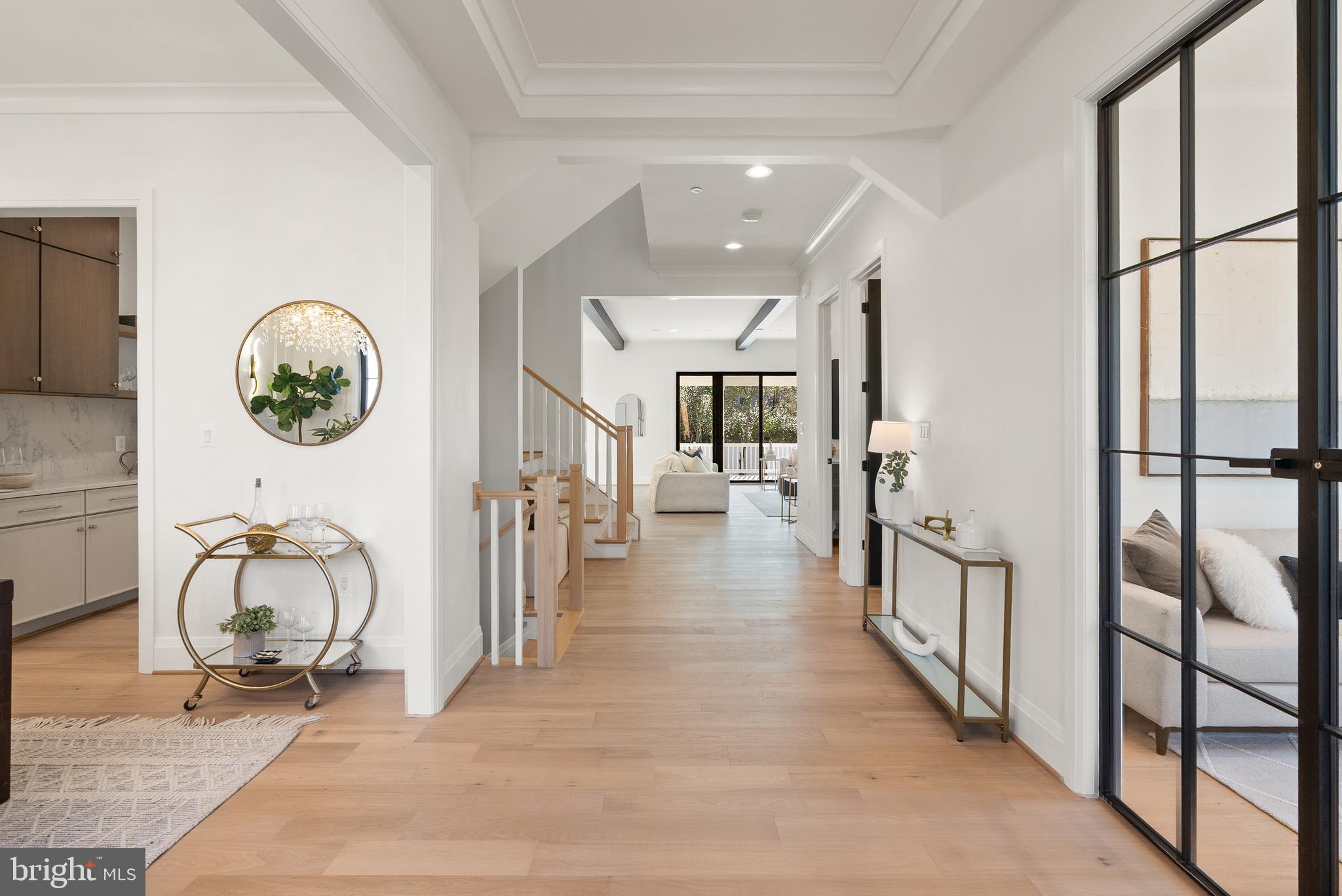 5804 Ridgefield Road Bethesda, MD 20816 - Photo 3 of 53 a view of a hallway with wooden floor and a chandelier