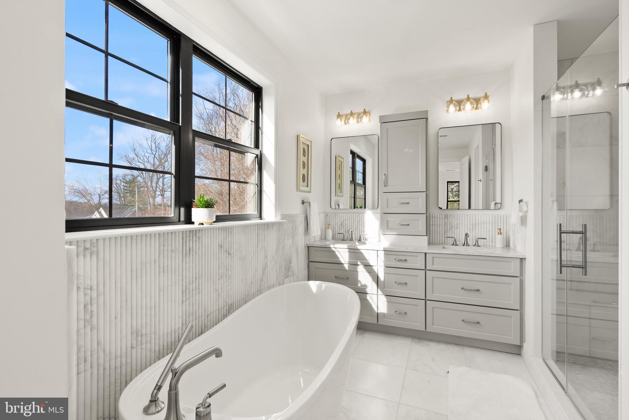 5804 Ridgefield Road Bethesda, MD 20816 - Photo 35 of 53 a bathroom with a tub sink and mirror