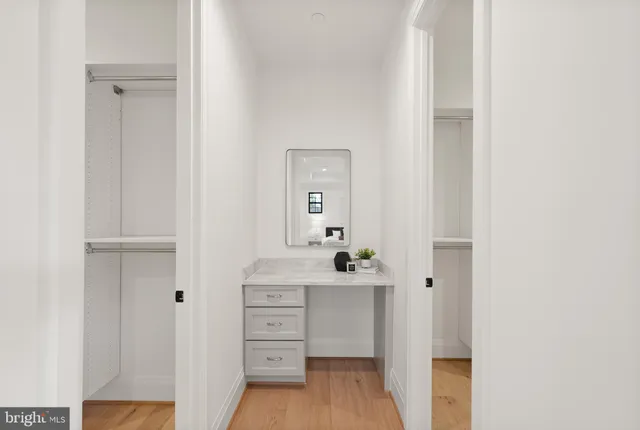 a bathroom with a shower sink vanity mirror and toilet