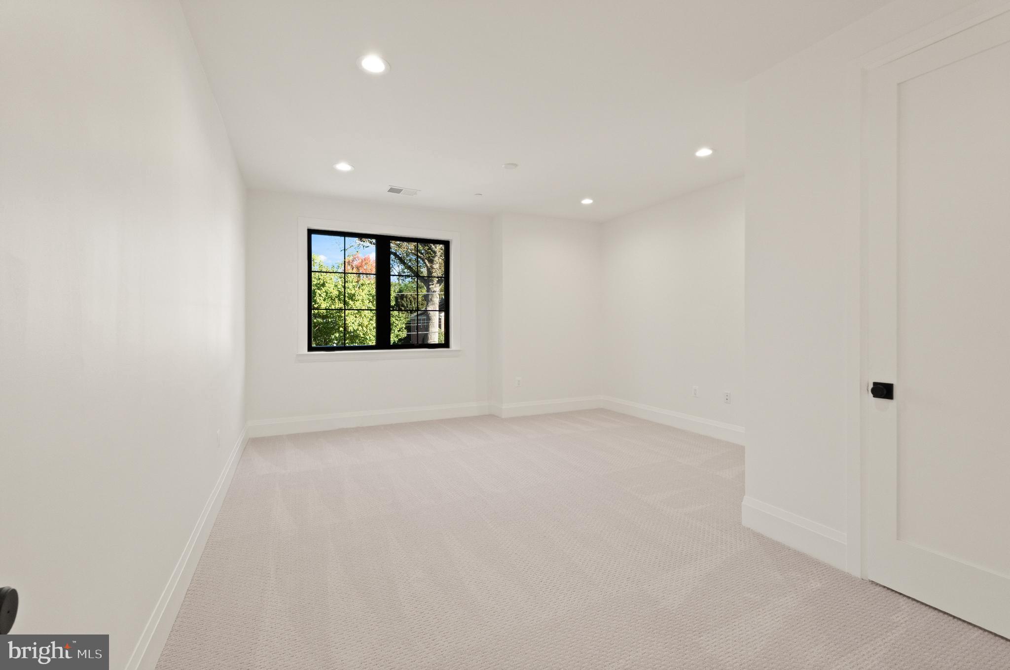 5804 Ridgefield Road Bethesda, MD 20816 - Photo 42 of 53 an empty room with a window and a hallway