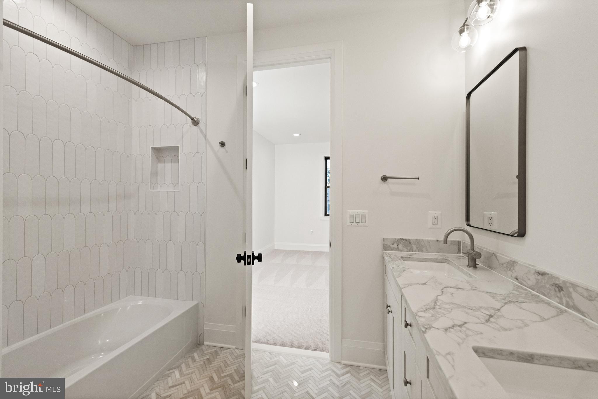 5804 Ridgefield Road Bethesda, MD 20816 - Photo 46 of 56 a bathroom with a tub sink and mirror