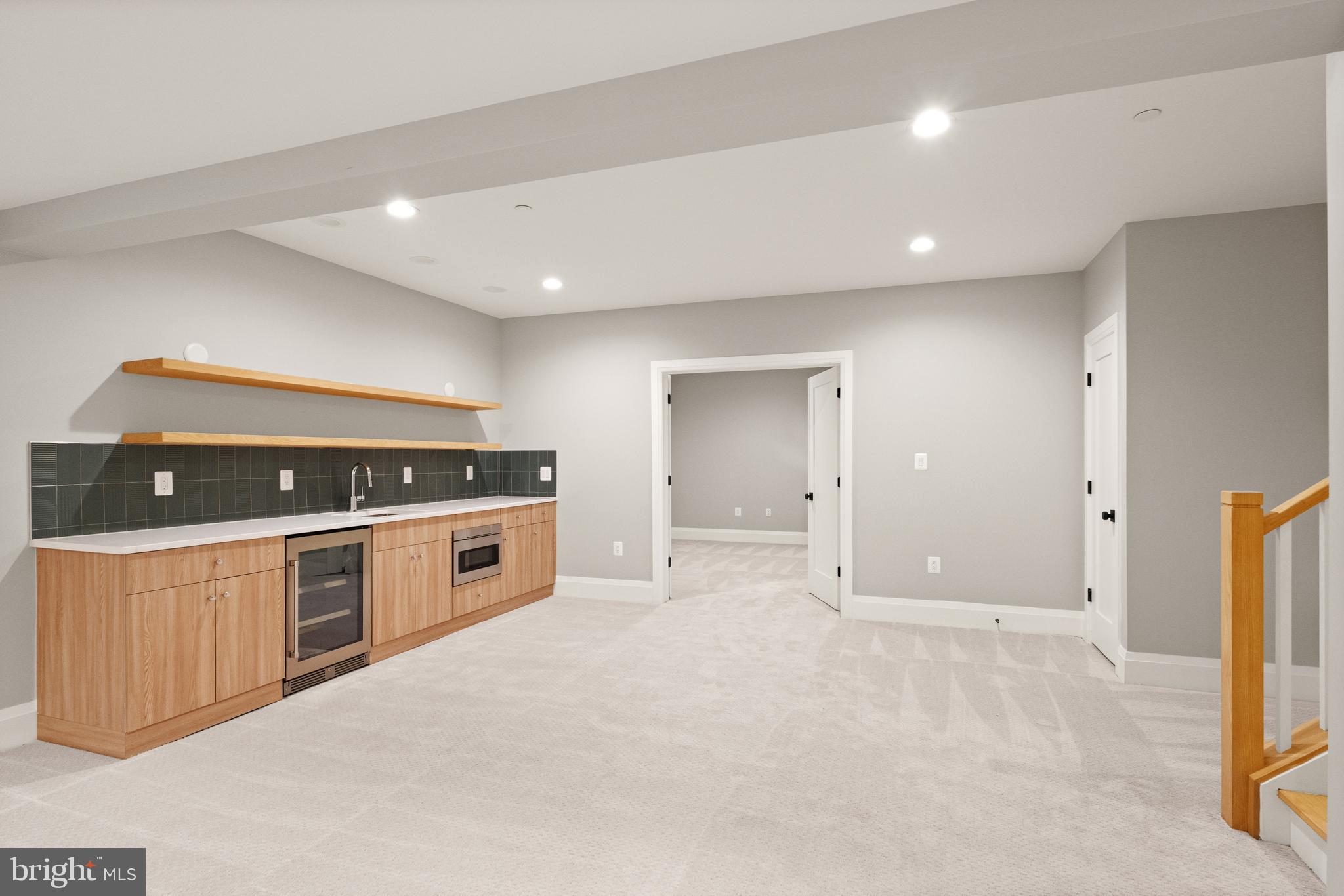 5804 Ridgefield Road Bethesda, MD 20816 - Photo 48 of 53 a large white kitchen with stainless steel appliances a stove a sink a refrigerator and white cabinets