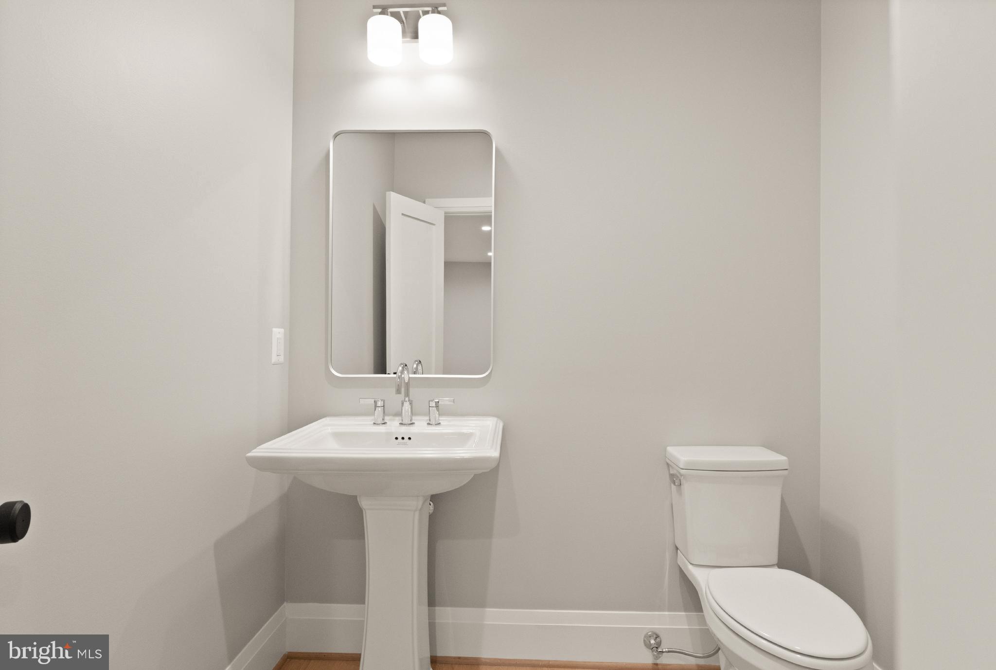 5804 Ridgefield Road Bethesda, MD 20816 - Photo 53 of 53 a bathroom with a sink a toilet and mirror