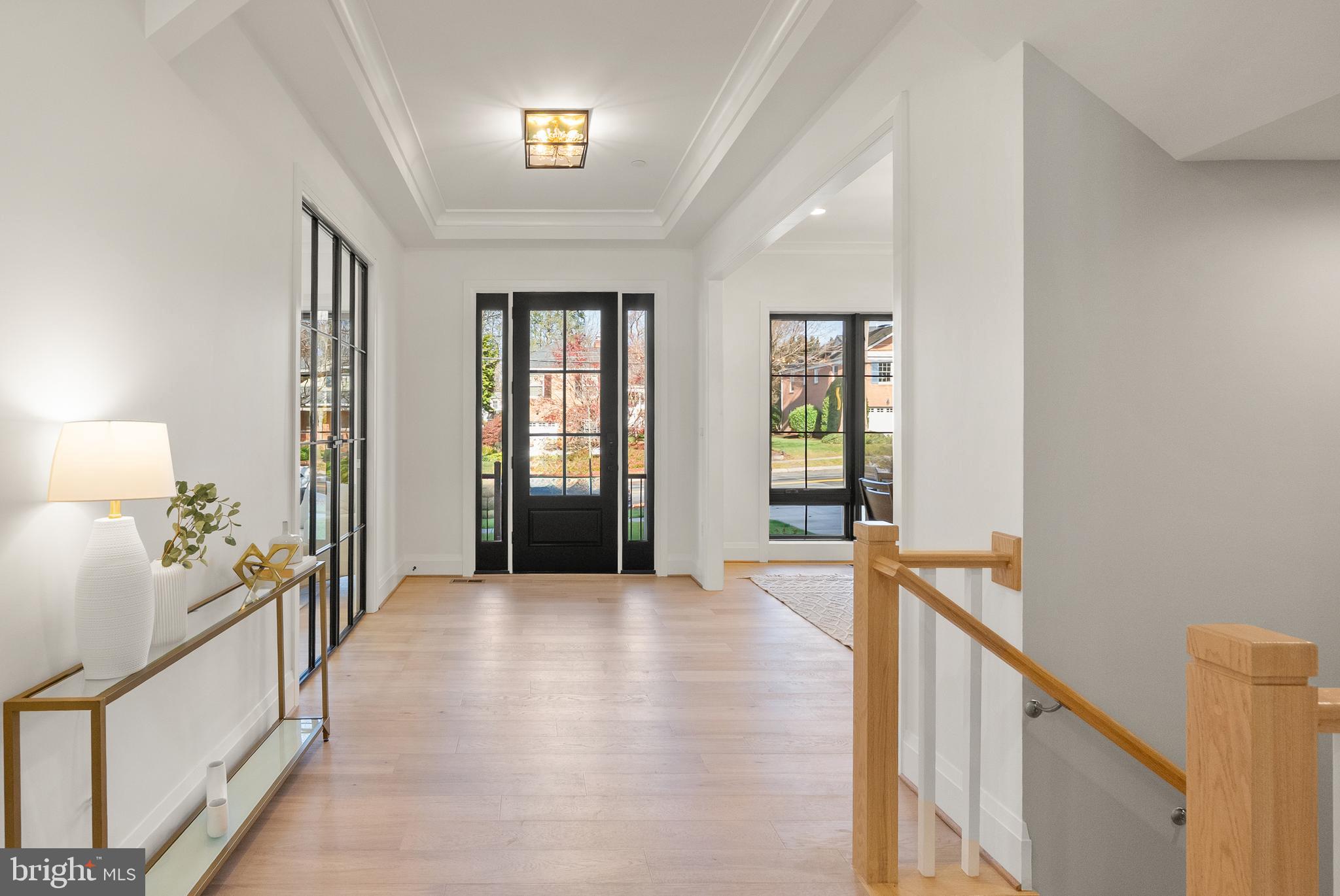5804 Ridgefield Road Bethesda, MD 20816 - Photo 9 of 56 a view of a hallway with wooden floor and livingroom with furniture