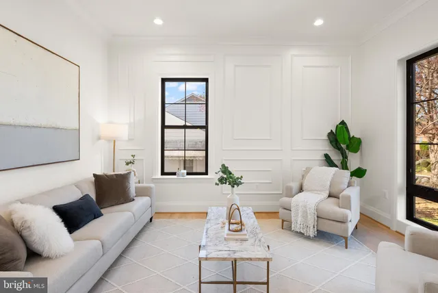 a view of a dining room with furniture and a potted plant