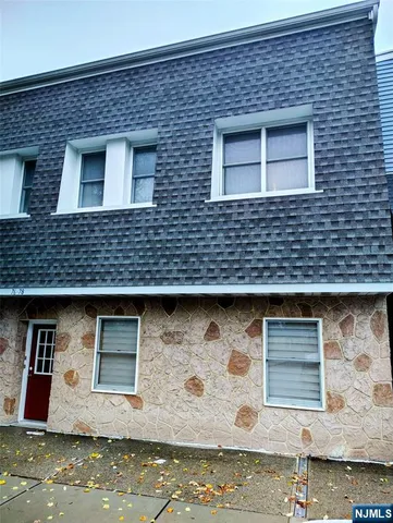 a view of a brick house with large windows