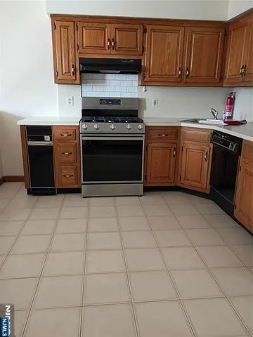 a kitchen with a cabinets and a stove top oven