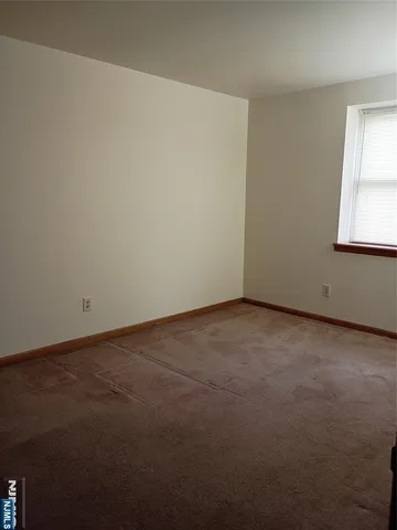 a view of an empty room and a window