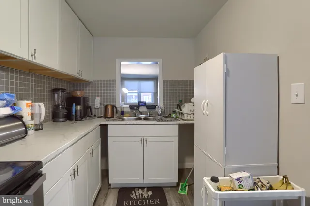 a kitchen with stainless steel appliances granite countertop a refrigerator and a stove