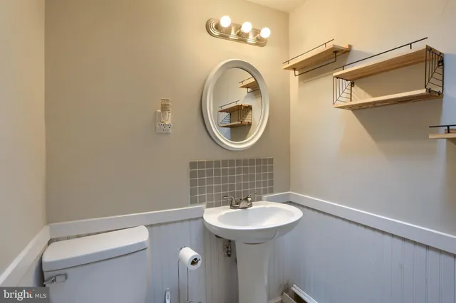 a bathroom with a sink a mirror and a shower
