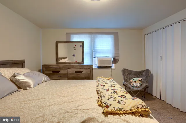 a bedroom with a bed and a chair