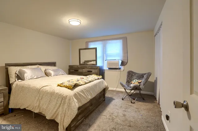 a bedroom with a bed and chair