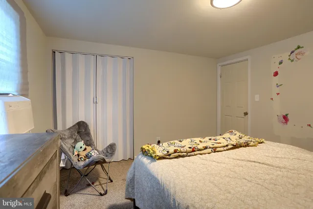 a bedroom with a bed and a white bed