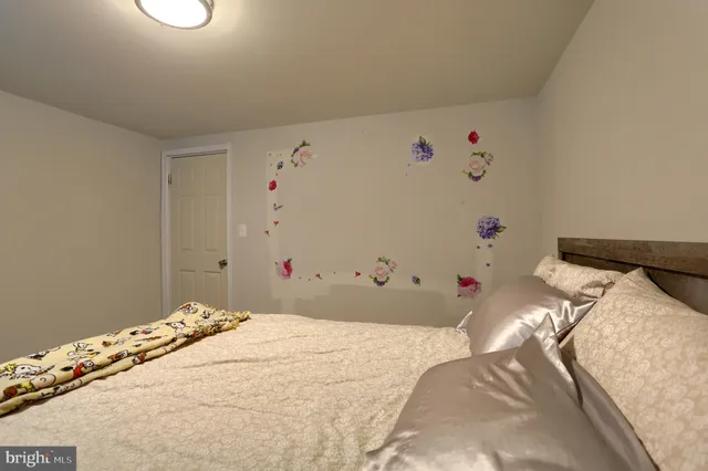 a bedroom with a bed and a mirror