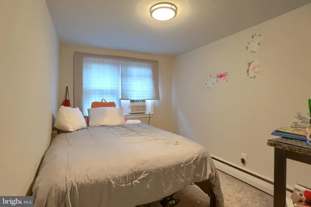 a bed room with a bed and a chair