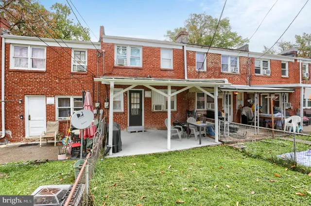 a view of a house with a yard patio and a garden