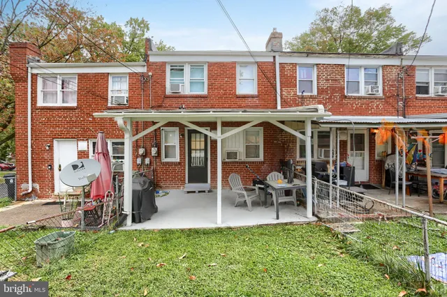 a view of a house with a yard patio and a slide