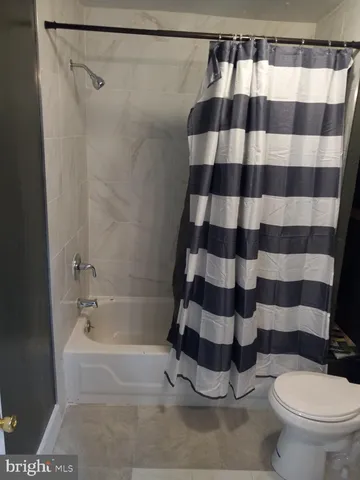 a bathroom with a black and white checkered floor