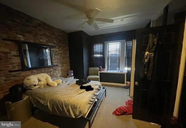 a bedroom with a bed a mirror and dresser