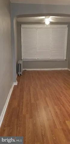 a view of a small space with wooden floor and a window