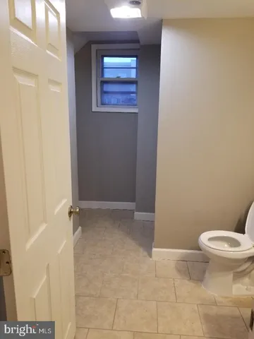 a kitchen with a refrigerator and a stove top oven