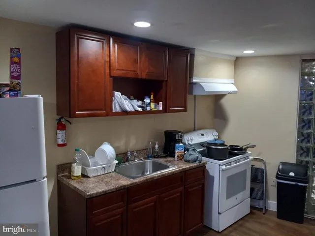 a kitchen with stainless steel appliances a stove a sink a refrigerator and cabinets