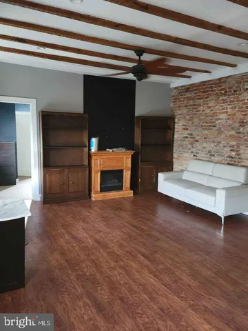 a view of a livingroom with an empty space and a fireplace