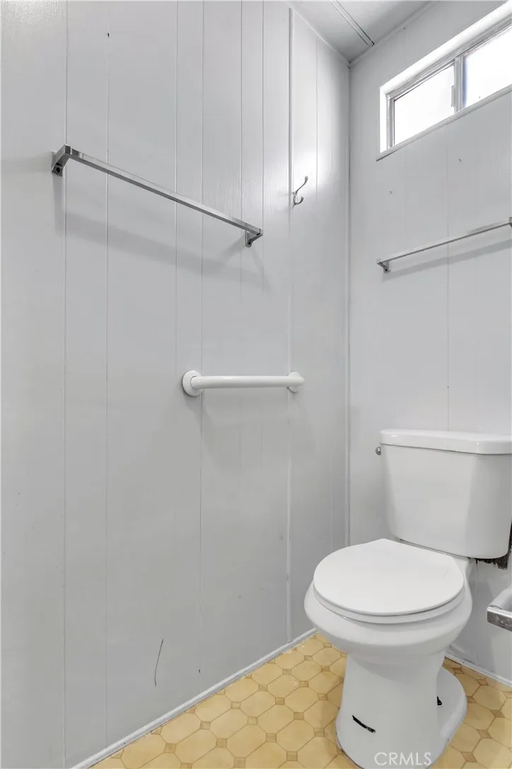 301 East Foothill Boulevard, Unit 34 Pomona, CA 91767 - Photo 14 of 35 a white toilet sitting next to a shower