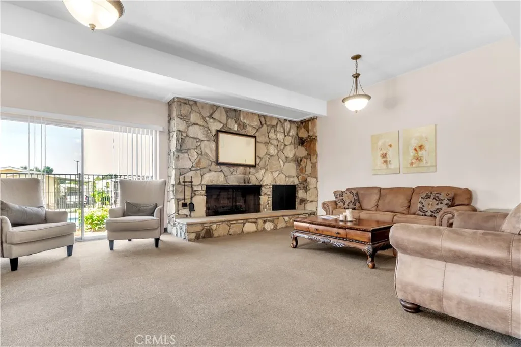 301 East Foothill Boulevard, Unit 34 Pomona, CA 91767 - Photo 18 of 35 a living room with furniture and a fireplace