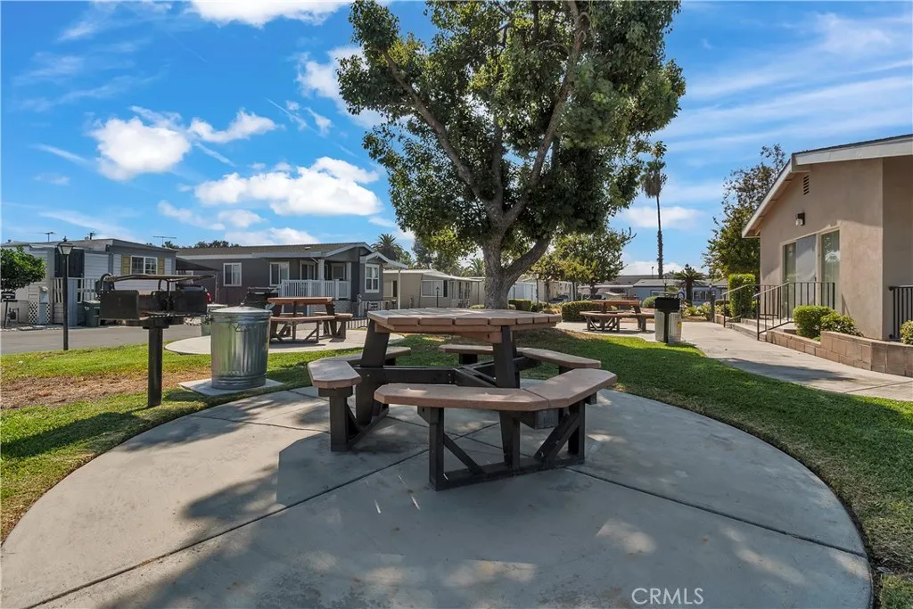301 East Foothill Boulevard, Unit 34 Pomona, CA 91767 - Photo 19 of 35 a swimming pool with outdoor seating and a garden