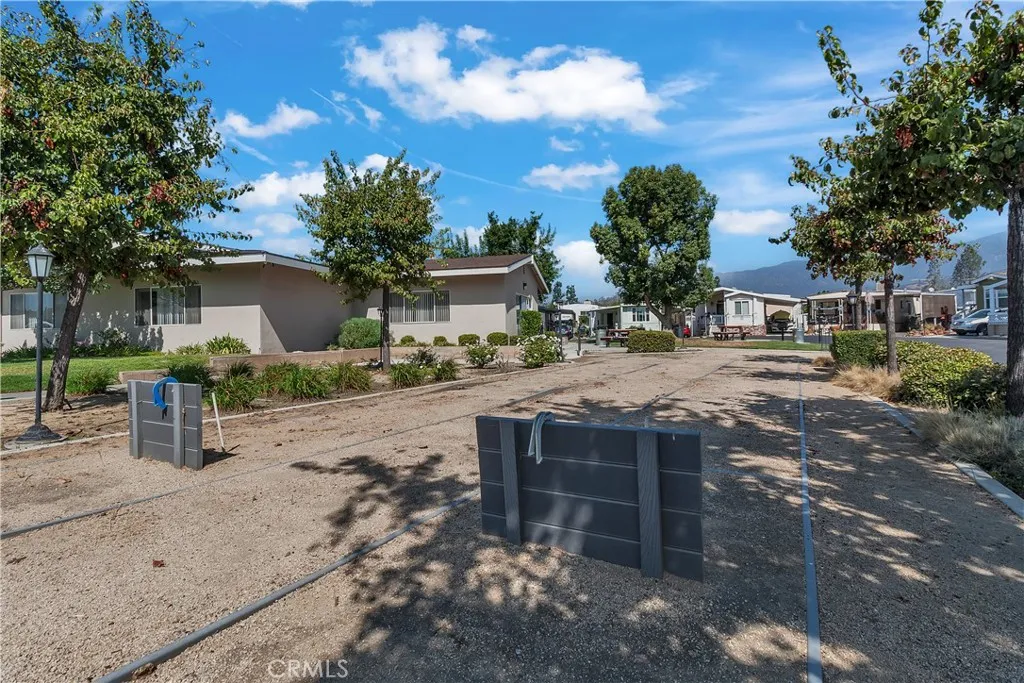 301 East Foothill Boulevard, Unit 34 Pomona, CA 91767 - Photo 20 of 35 a view of a house with a yard