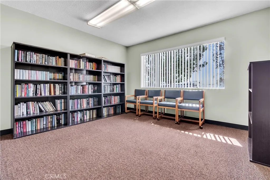 301 East Foothill Boulevard, Unit 34 Pomona, CA 91767 - Photo 23 of 35 a living room with furniture and a book shelf