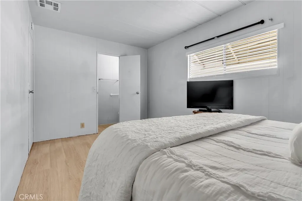 301 East Foothill Boulevard, Unit 34 Pomona, CA 91767 - Photo 32 of 35 a bedroom with a bed and a flat screen tv