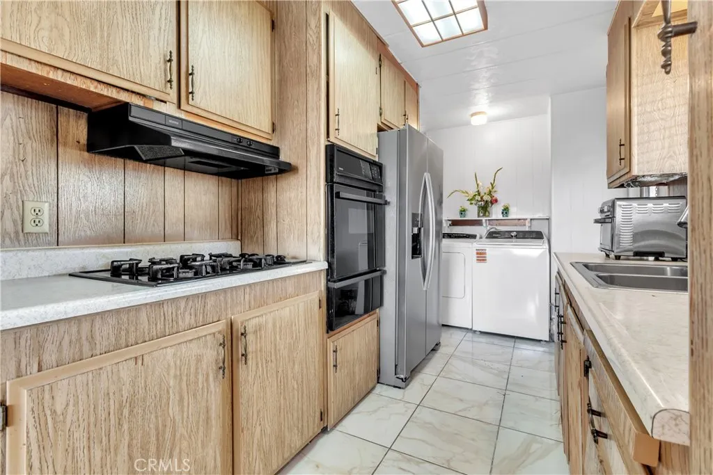 301 East Foothill Boulevard, Unit 34 Pomona, CA 91767 - Photo 4 of 35 a kitchen with stainless steel appliances granite countertop a stove a refrigerator and a sink