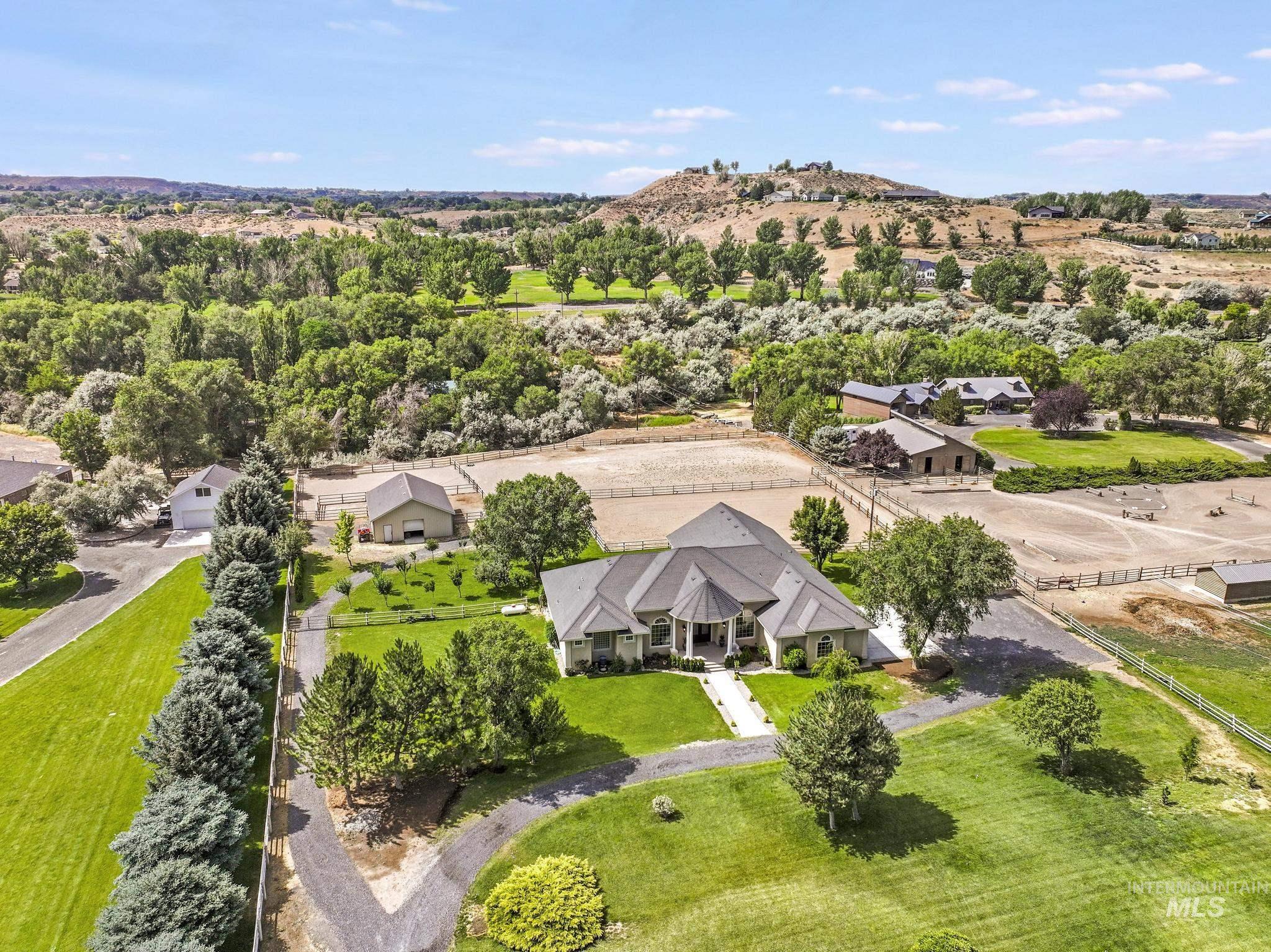1301 Kanaka Rapids Road Buhl, ID 83316 - Photo 2 of 50 Expansive property featuring a large residence, manicured lawns, and multiple outbuildings